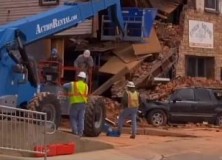 Crews work to remove rubble from collapsed building.