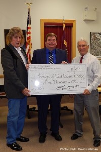 County Executive McClure presents CDBG check to Mayor DePaul (left) and Council Pres. Paul James (right).